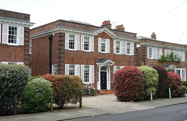 Neo-Georgian houses on Heath Drive in the Gidea Park conservation area with hedged front gardens and gravel frontages